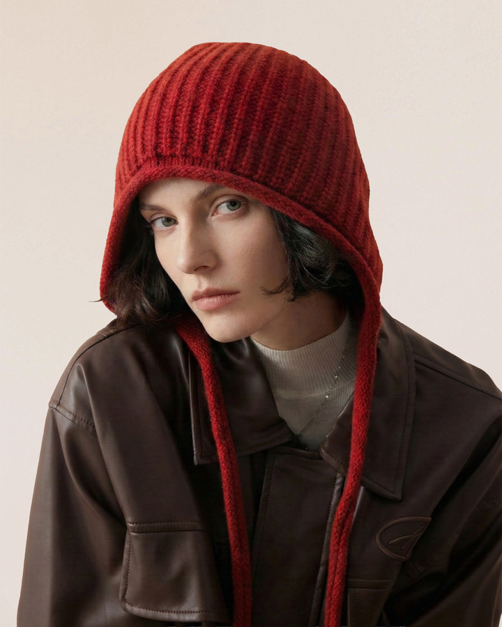 VIONIS·XY merino tie-bonnet in scarlet, front view showing face-framing shape, crafted from 100% 16S merino wool