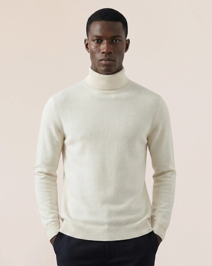 Side view of VIONIS·XY 100% Inner Mongolia Cashmere turtleneck in Soft Ivory showing tailored silhouette