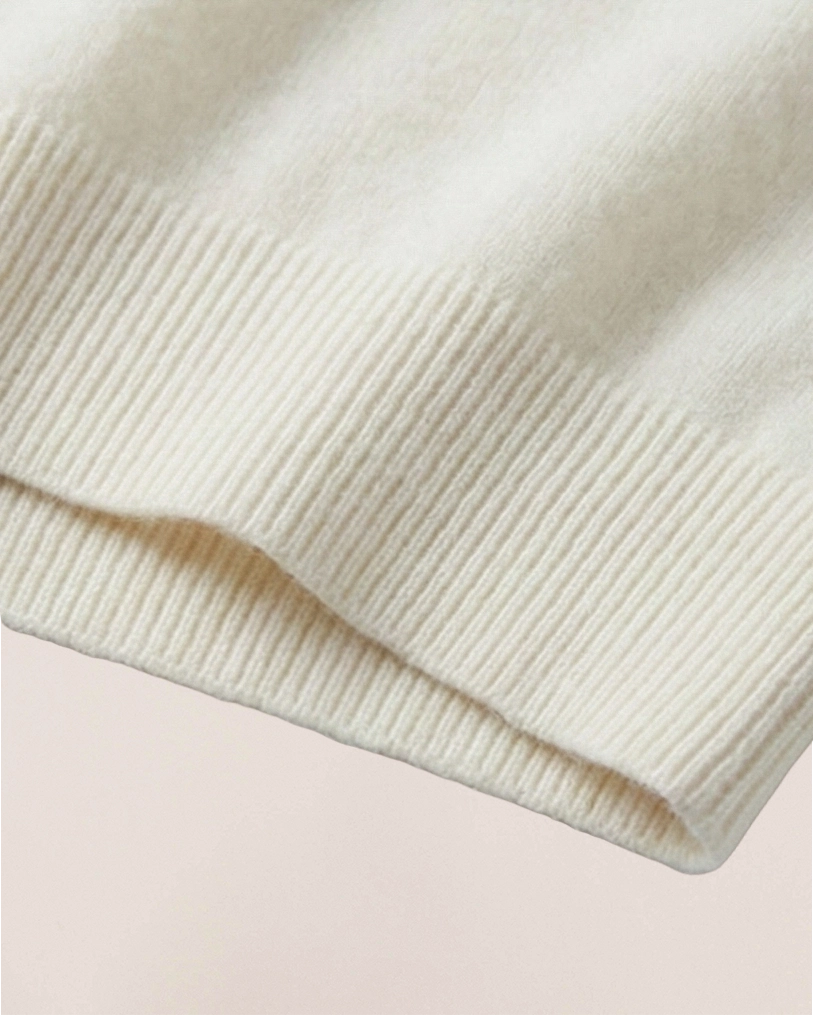 Fabric close-up of VIONIS·XY 100% Inner Mongolia Cashmere knit in Soft Ivory, ultra-soft texture